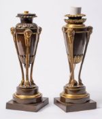 A matched pair of Empire-style bronze and ormolu side ornaments: in the form of amphora with sphinx