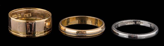 An 18ct gold two colour band 3.5gms, a 9ct gold band 2.4gms and a platinum band 4gms.