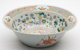 A Chinese famille rose basin: painted to the centre with a peacock amongst prunus and peony,