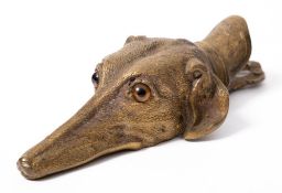 A Victorian gilt-brass stationery clip in the form of a dog's head: with glass eyes, 15cm.