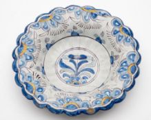 A Brislington polychrome delftware lobed dish: painted in blue,
