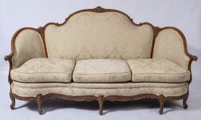 A French carved and decorated beechwood three seat settee and matching armchair:,