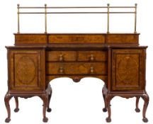 A Maple and Co walnut, crossbanded and inlaid sideboard:, of recessed breakfront outline,