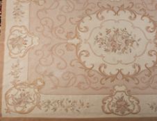 An Aubusson tapestry carpet:, the ivory field with a central bouquet of roses within a cartouche,