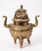 A bronze censer and cover: the domed cover with pierced foliate decoration surmounted by a