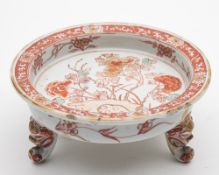 An unusual Chinese verte-imari tripod stand: painted in iron-red,