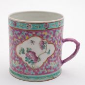 A Chinese famille rose cylindrical mug for the Straits market: painted with panels of peony sprays