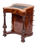A Victorian walnut Davenport:, of unusual cartouche outline,