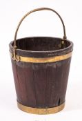 An early 19th Century mahogany and brass bound peat bucket:, with swing carrying handle,