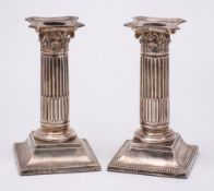 A pair of Victorian silver Corinthian column dressing table candlesticks, maker Martin, Hall & Co,