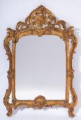 A contemporary carved giltwood marginal wall mirror:, of cartouche shaped outline,