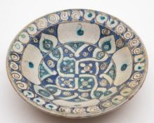 A pottery bowl in the Isnik manner: painted in white,