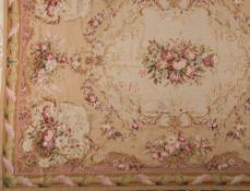A flatweave carpet of Aubusson type:, the beige field with a central bouquet of flowers and foliage,