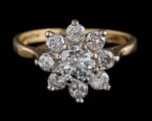 An 18ct gold and diamond floral cluster ring: set with round,