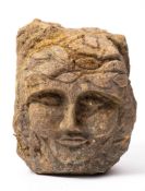 A carved stone corbel, 'The Green Man': 21cm. high.