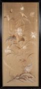 A Japanese silk embroidery: depicting a crane amongst flowering shrubs and butterflies,