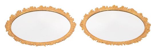 A pair of 19th Century carved giltwood oval mirrors:,