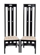 A pair of Rennie Mackintosh style high back ebonised side chairs,: with drop-in seats, each 150.