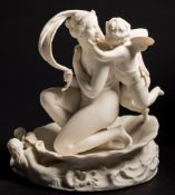 A Minton parian group of 'Venus and Cupid in a Shell': the goddess kneeling in a large conch shell,