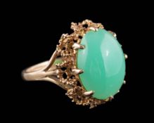 A 9ct gold and jade single-stone ring: the oval jade approximately 16mm long x 11.