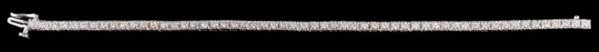 A hallmarked 18ct white gold and diamond tennis bracelet: illusion-set with round brilliant-cut