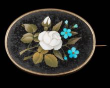 A pietra dura oval brooch: depicting a floral bouquet approximately 56mm long overall,