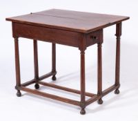 An 18th Century oak rectangular tea table:, the hinged top with double gateleg action,
