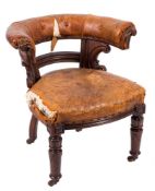 A Victorian carved mahogany library armchair:,
