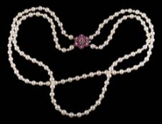 A cultured pearl two-string necklace: with ruby and diamond mounted circular cluster clasp stamped