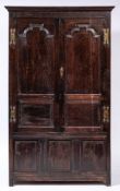 An 18th Century oak side cupboard:, with a moulded cornice,