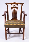 A George III mahogany elbow chair in the Chippendale taste:,