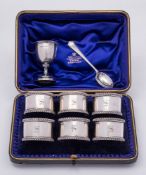 A set of six Edward VII silver napkin rings, maker Wakely & Wheeler, London, 1901: initialled,