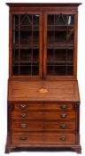 A George III mahogany and inlaid bureau and associated bookcase:,