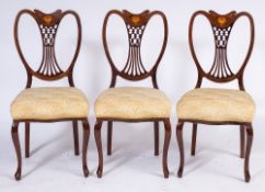 An Edwardian mahogany and inlaid seven piece salon suite:,