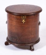 An 18th Century oak drum shaped commode:, with a hinged moulded top and interior cover,