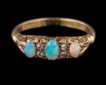 An 18ct gold, opal and diamond seven-stone ring: set with graduated,