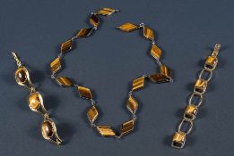 A 'tigers-eye' diamond panel shaped necklace with two gold plated bracelets.