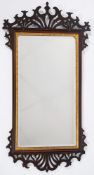 A late 19th Century mahogany and pierced fret carved wall mirror in the Georgian taste:,