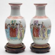 A pair of Chinese famille rose baluster vases: each painted with a presentation scene depicting an