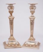 A pair of silver plated candlesticks: in neo-classical style,