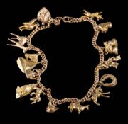 A 9ct gold curb-link chain with various attached gold charms: to include owl charm,