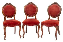 A set of six Victorian carved walnut dining chairs:,