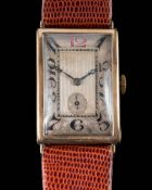 A gentleman's 9ct gold cased manual wind wristwatch: the rectangular dial with Arabic numerals and
