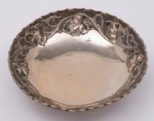 A Continental silver dish, stamped marks: of circular outline, with embossed vine leaf decoration,