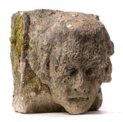 A carved stone corbel: depicting a gentleman's head with wavy hair, 23cm high.