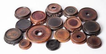 A mixed group of Oriental wooden stands: of carved and pierced circular form.