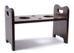 A mahogany decanter drainer stand: the central board with recesses for two decanters and stoppers,