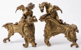 A pair of 19th century French brass chenets: surmounted by winged griffons,