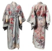 A Japanese silk kimono: embroidered with flowers and foliage on a pale blue ground, approx.