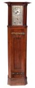 An Art & Crafts oak longcase clock: the eight-day duration weight-driven movement striking the